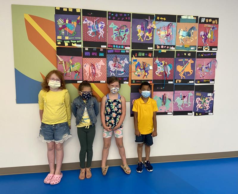 Students (l-r) Sophia Mockewich, Praiana Delcampo, Caroline Rausch and Santhiago Vieira show off their mixed-media carousel horses.